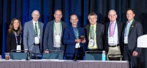Dr. Safran (center) holds the symposium’s Golden Apple Award for best teaching case, in which he showed his management of a dislocated lens-bag complex and a failed PK in a monocular patient. Source: ASCRS